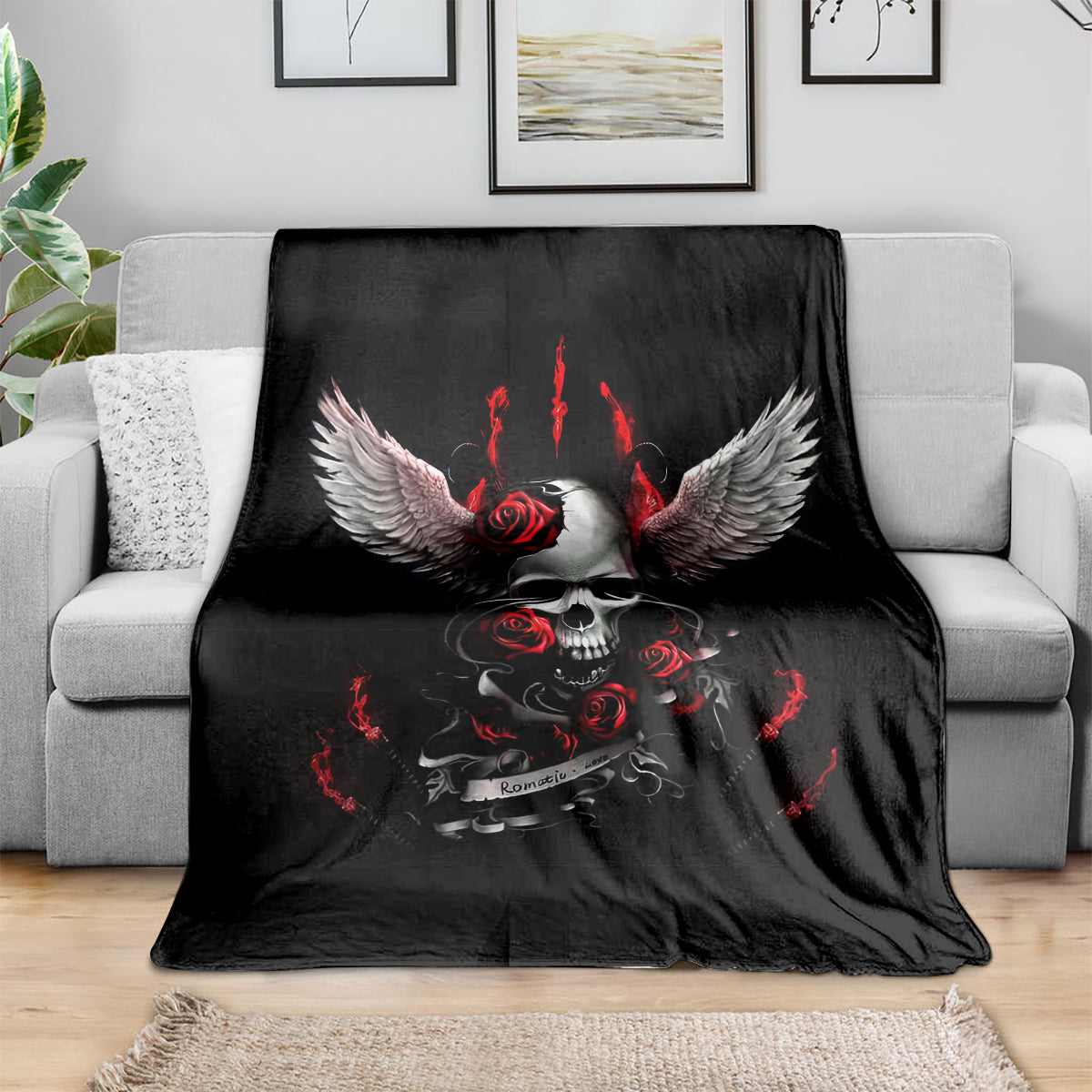 Black skull wings blanket with red roses and flames, spread across a sofa