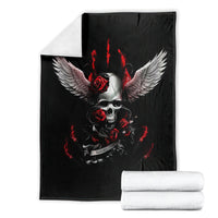 Black skull and wings blanket with red roses and flames, laid out with rolled towels