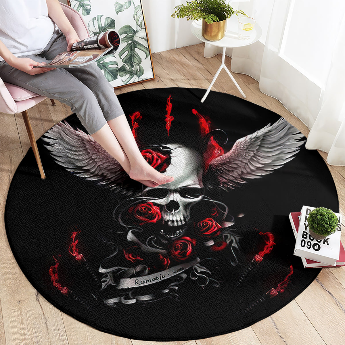 Black round rug featuring skull center, red accents, and large feathered wings