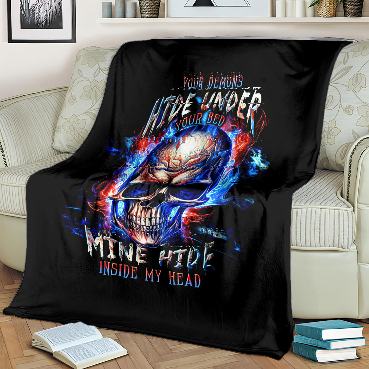 Black throw blanket on couch with fiery blue-red skull graphic and flame accents