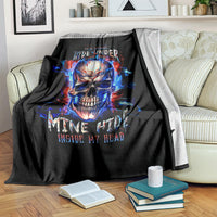 Black blanket over couch with fiery blue-red skull graphic and flame accents