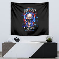Black skull tapestry with flaming blue-red artwork, on wall above a white console