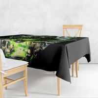 Black tablecloth on dining table with green skull-and-chains print, draped
