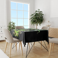 Black tablecloth with green skull and lightning motif, draped on dining set
