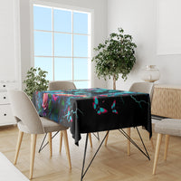 Black tablecloth with colorful skull and roses artwork, butterfly motifs, draped sides