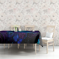 Black tablecloth with blue and purple skull roses graphic on dining table.