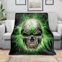 Black and green skull lightning blanket laid across a sofa