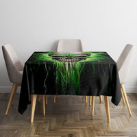 Black tablecloth with green lightning skull print on square table, four chairs