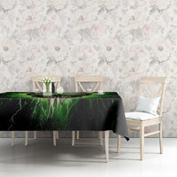 Black tablecloth with green lightning skull graphic on dining table with chairs
