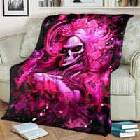 Skull lady blanket with black background and vivid pink hair, skull face, and roses