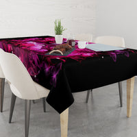 Black tablecloth with purple skull-lady fantasy print and draped corner over dining table
