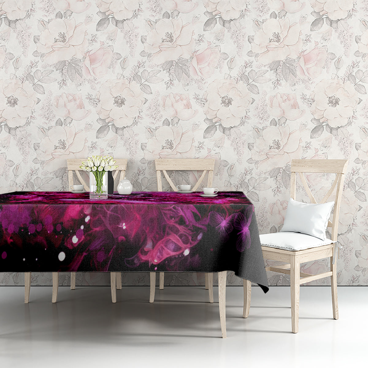 Black tablecloth with purple skull-lady splash print on dining table, edge and hem visible