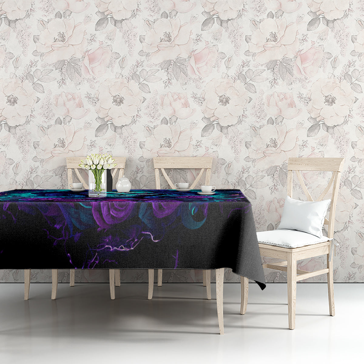 Black tablecloth with purple-blue skull and rose design on dining table against wall
