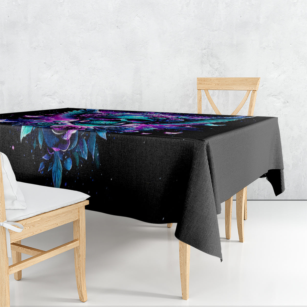 Black skull-and-wings tablecloth draped over a table, purple and blue design