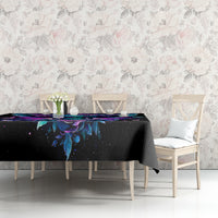 Black skull-and-wings tablecloth with colorful purple/blue artwork on tabletop