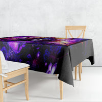 Black tablecloth with purple fantasy pattern draped on dining table, corner view