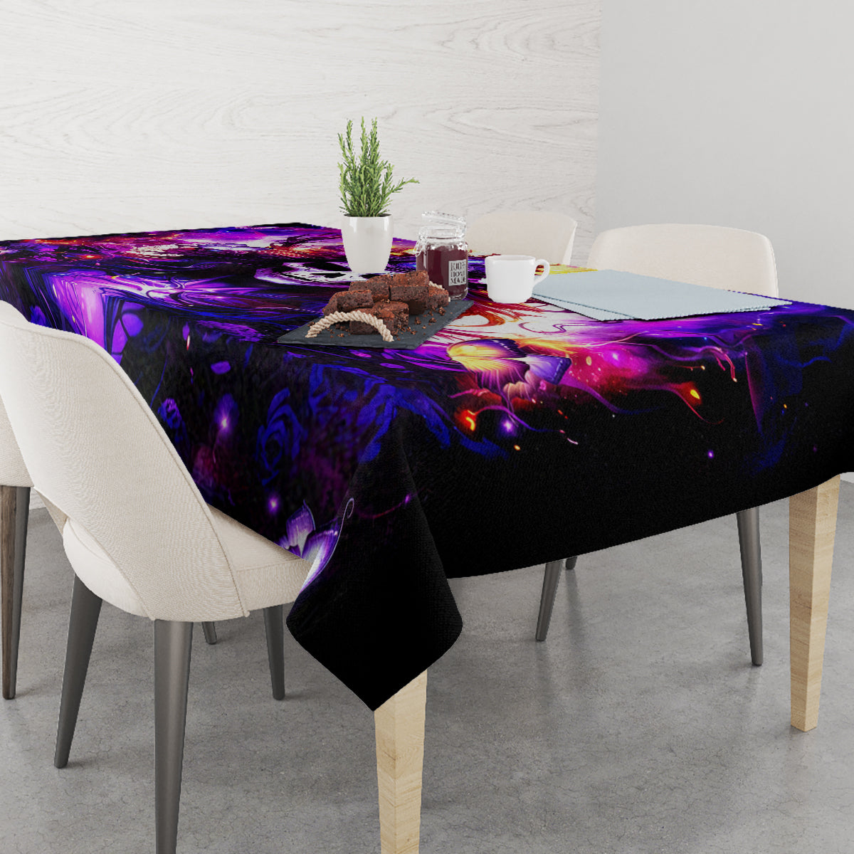 Black tablecloth with purple fantasy graphic, rectangular table with centerpiece