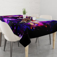 Black tablecloth with purple fantasy graphic, rectangular table with centerpiece