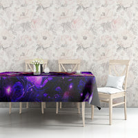 Black tablecloth with purple mystical artwork, dining table against floral wall