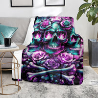 Purple and teal skull rose blanket folded on gray chair