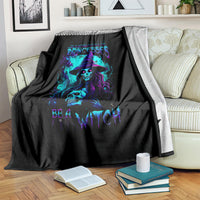 Black witch skull throw blanket with neon purple and blue graphic, on sofa