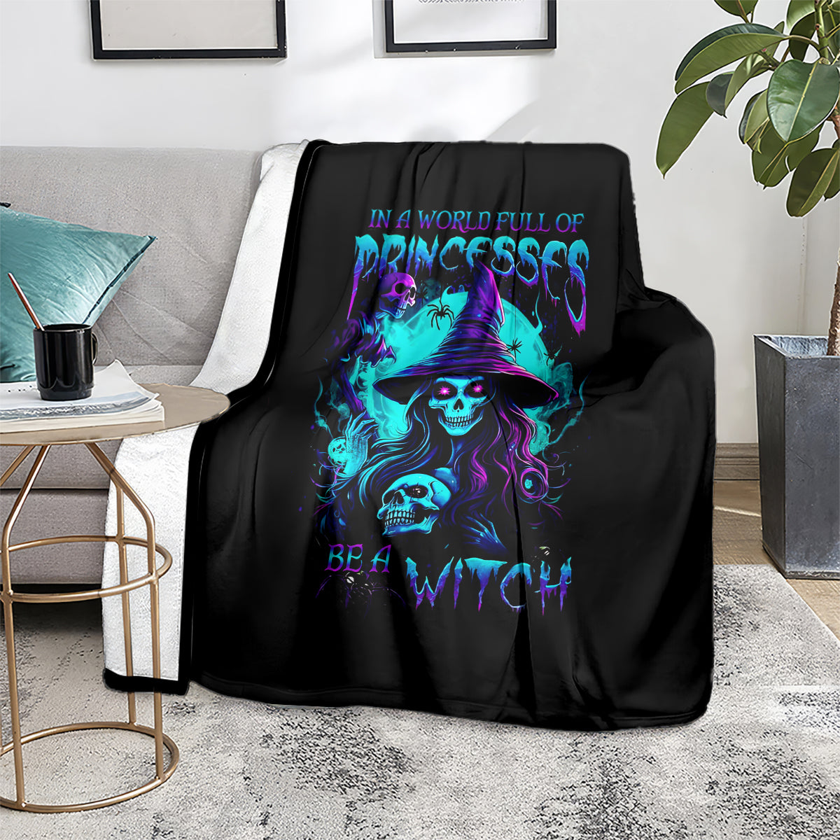 Black witch skull throw blanket with neon purple and blue graphic, draped over sofa