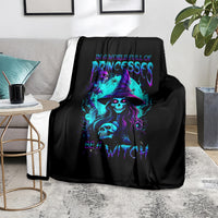 Black witch skull throw blanket with neon purple and blue graphic, draped over sofa