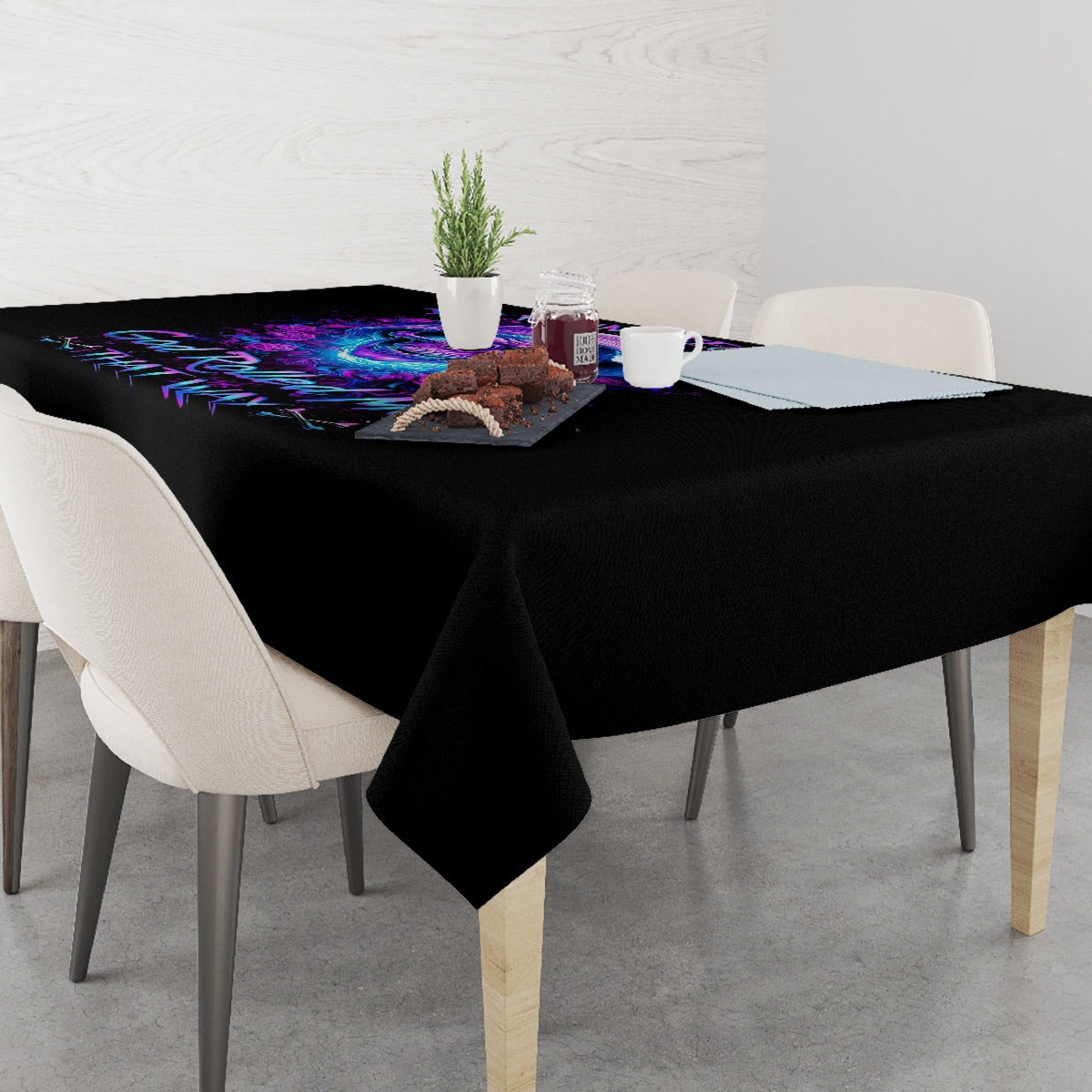 Black tablecloth with purple neon skull-and-rose print, spread on dining table