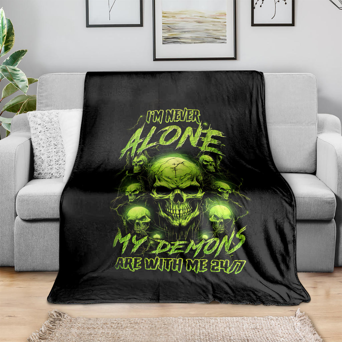 Black throw blanket with neon green skull graphic and I'M NEVER ALONE