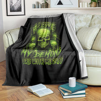 Black throw blanket draped on sofa with neon green skull design and ARE WITH ME 24/7