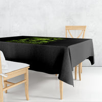 Black square tablecloth with neon green skull and text graphic, draped on table