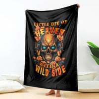 Black throw blanket with flaming skull and roses artwork, hanging display
