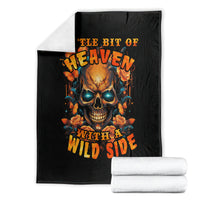 Black throw blanket with flaming skull and roses artwork, folded neatly