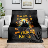 Black skull and hooded figure graphic blanket with sunflowers and bold orange lettering