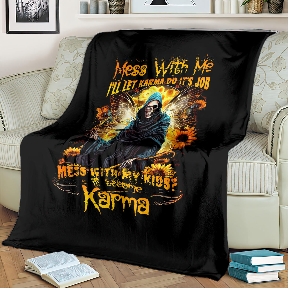 Black skull graphic throw blanket with hooded figure and sunflowers, draped on a sofa