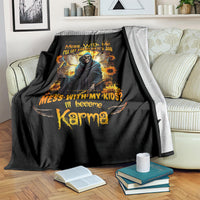 Black skull and sunflower graphic blanket draped over sofa, with orange and yellow lettering