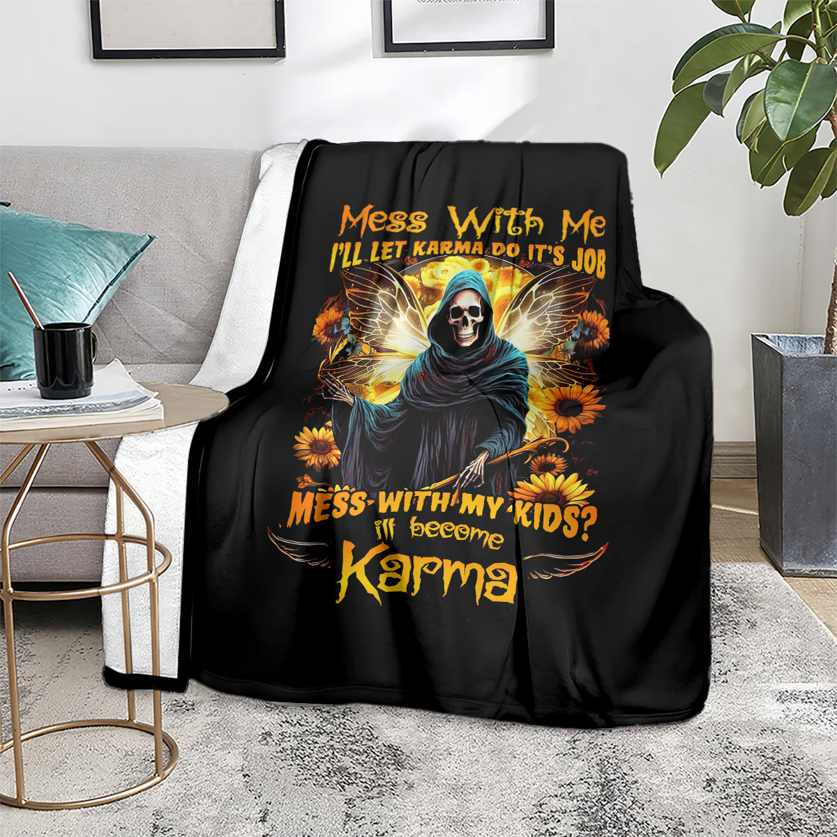 Black hooded skull graphic blanket on couch, sunflower accents and orange text