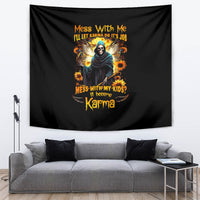 Black tapestry with hooded skull graphic, sunflower burst, and Karma quote typography.