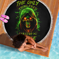 Black round beach blanket with green glowing skull graphic and white fringe