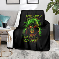 Black skull graphic throw blanket on a living room chair with green flame face print