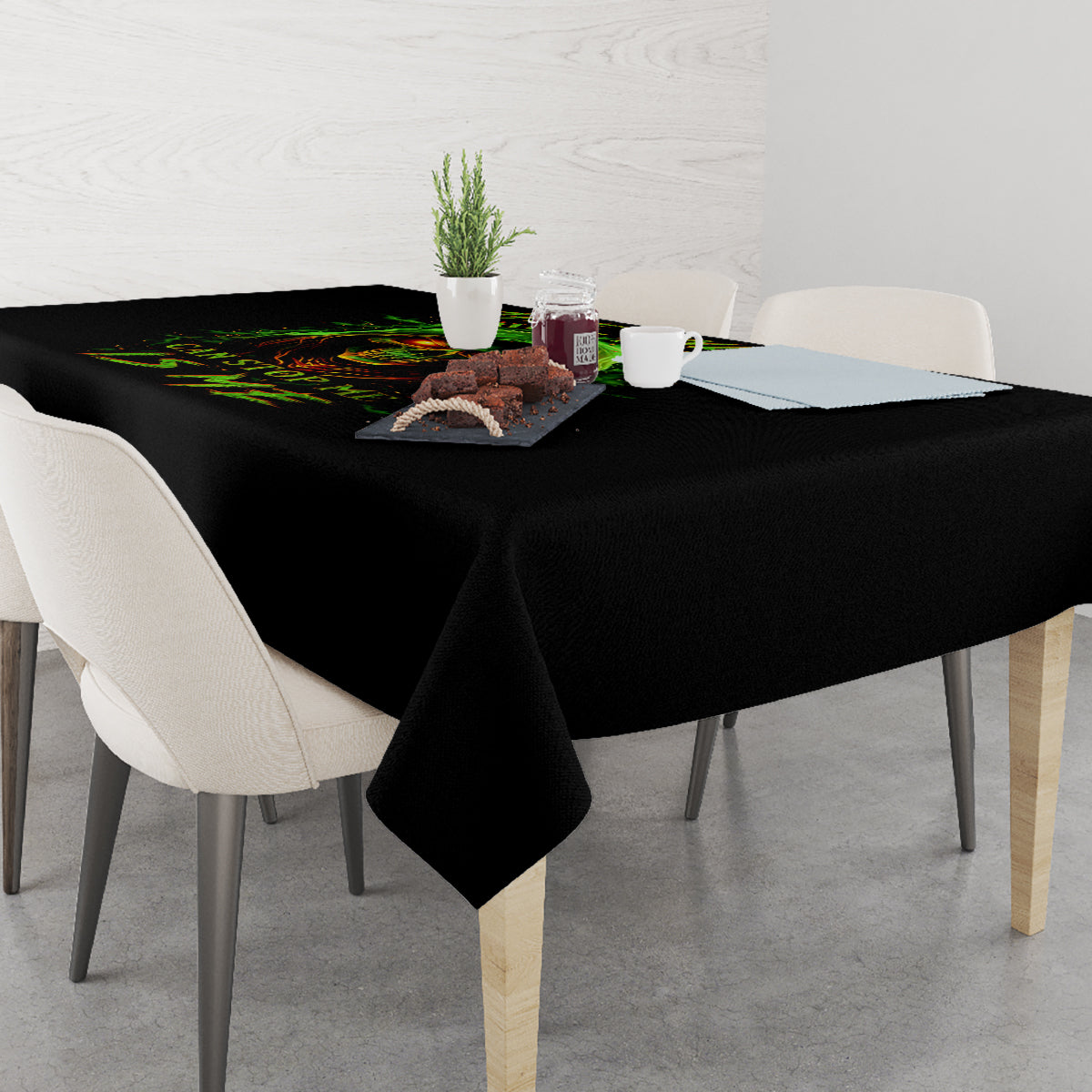 Black tablecloth draped over dining table with fiery skull neon graphic
