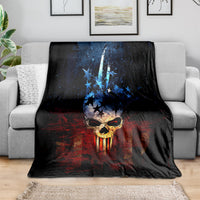 Black skull graphic blanket draped over gray sofa with blue stars and red pattern