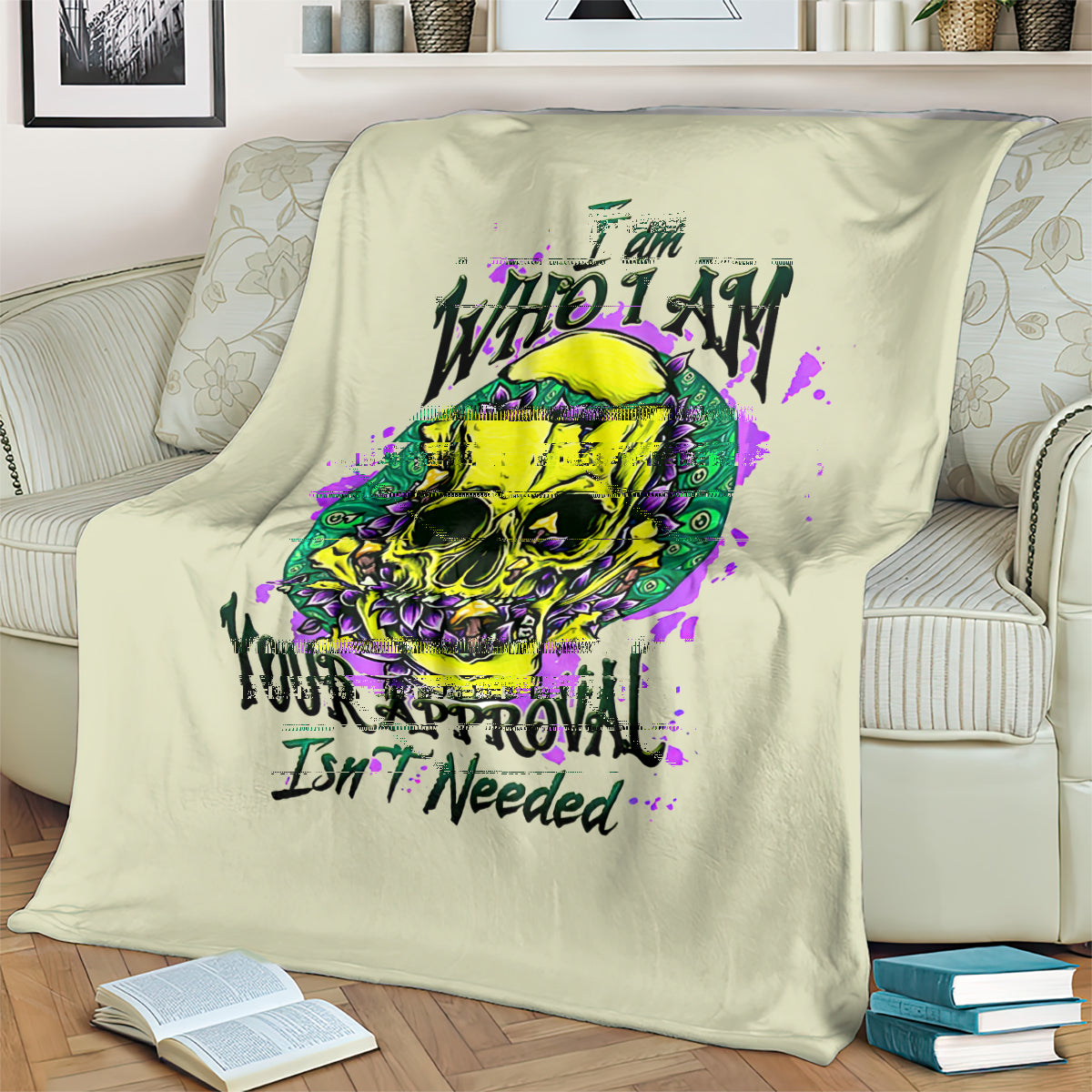 Light green blanket draped on a sofa showing a colorful skull and purple splashes