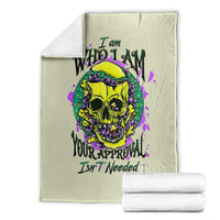 Light green blanket folded with colorful skull graphic and purple splatter accents