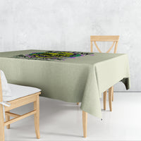 Green tablecloth with colorful skull-and-flower graphic centered on top