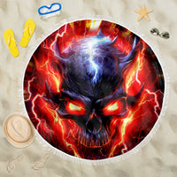 Round beach blanket with flaming blue-red skull artwork and white fringed edge