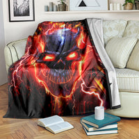 Black flame skull graphic blanket draped on a couch