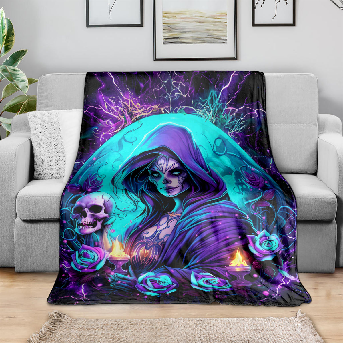 Hooded witch skull blanket on sofa, teal face, purple roses, candle flames, glowing aura