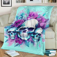 Turquoise skull blanket with purple orchids, laid over a couch back and arm