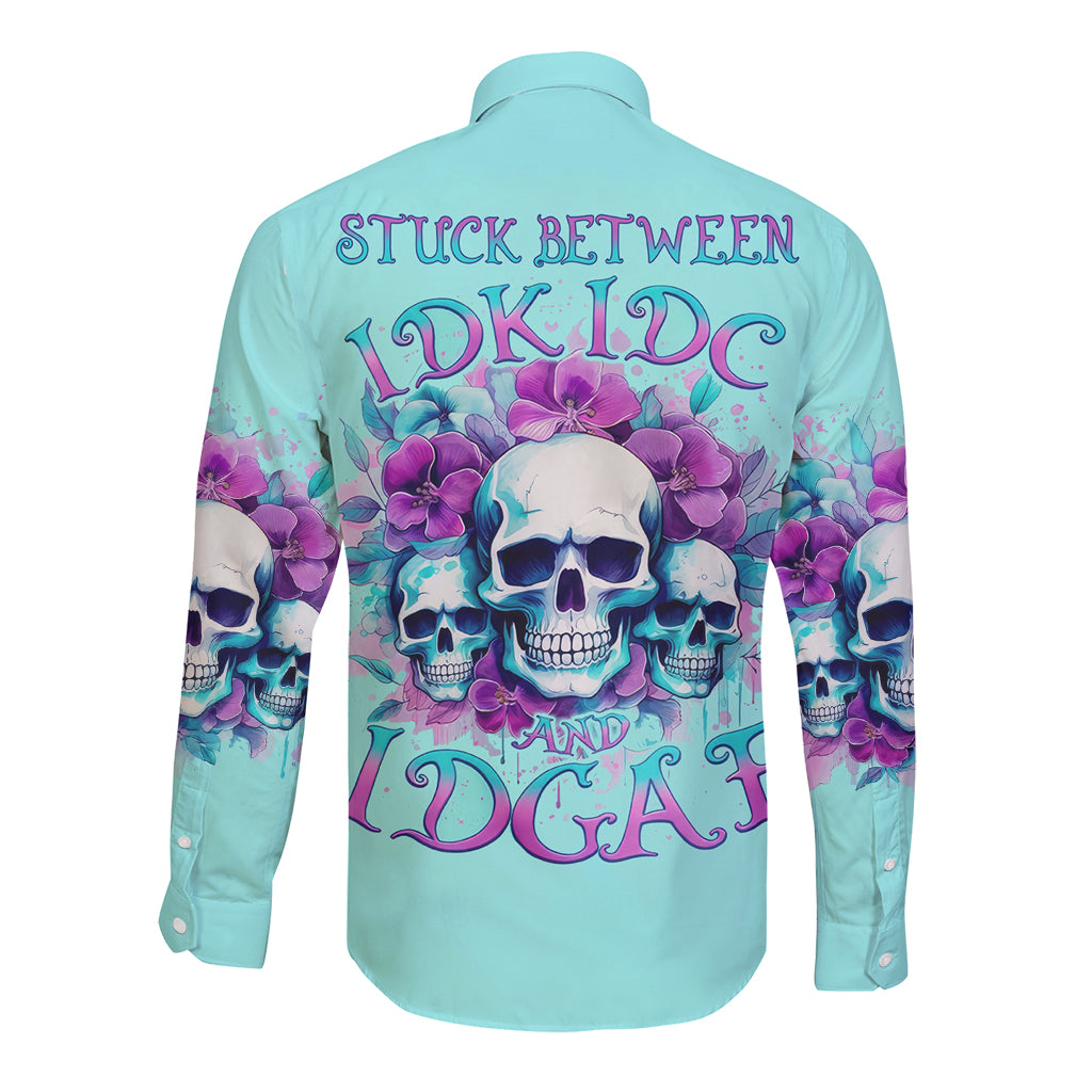 Turquoise long sleeve button shirt with skulls, flowers, and back graphic